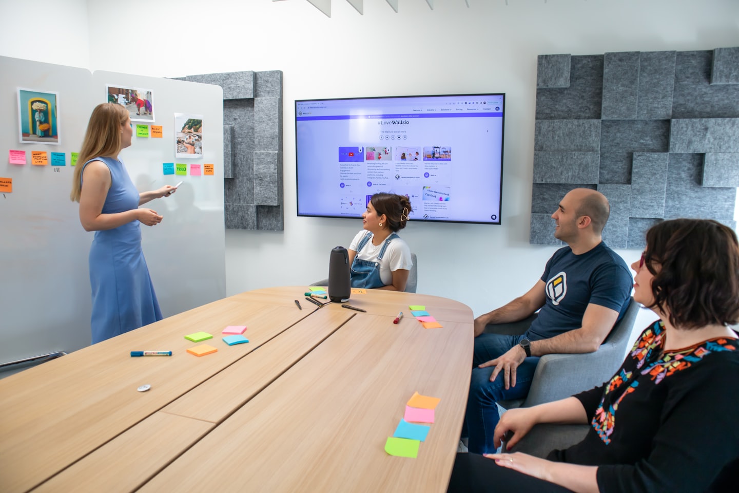 Team brainstorming ideas on a whiteboard with sticky notes.